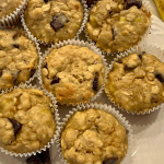 banana chocolate chunk muffins with oatmeal on a white plate