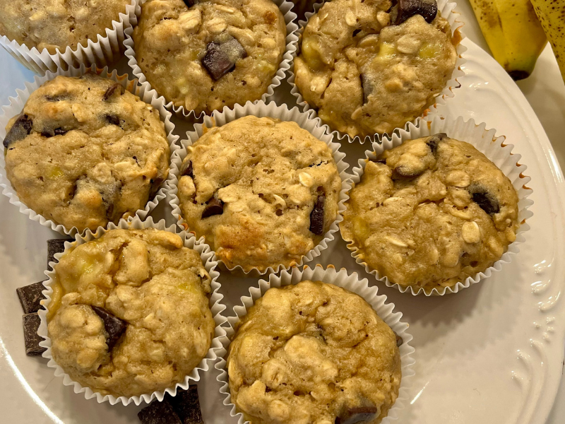 banana chocolate chunk muffins with oatmeal on a white plate